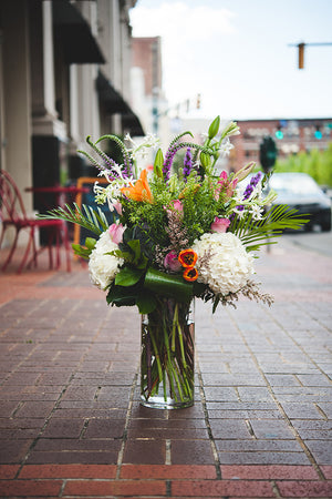 Blue Ivy Flowers - Grand Seasonal Boquet in glass vase on sidewalk